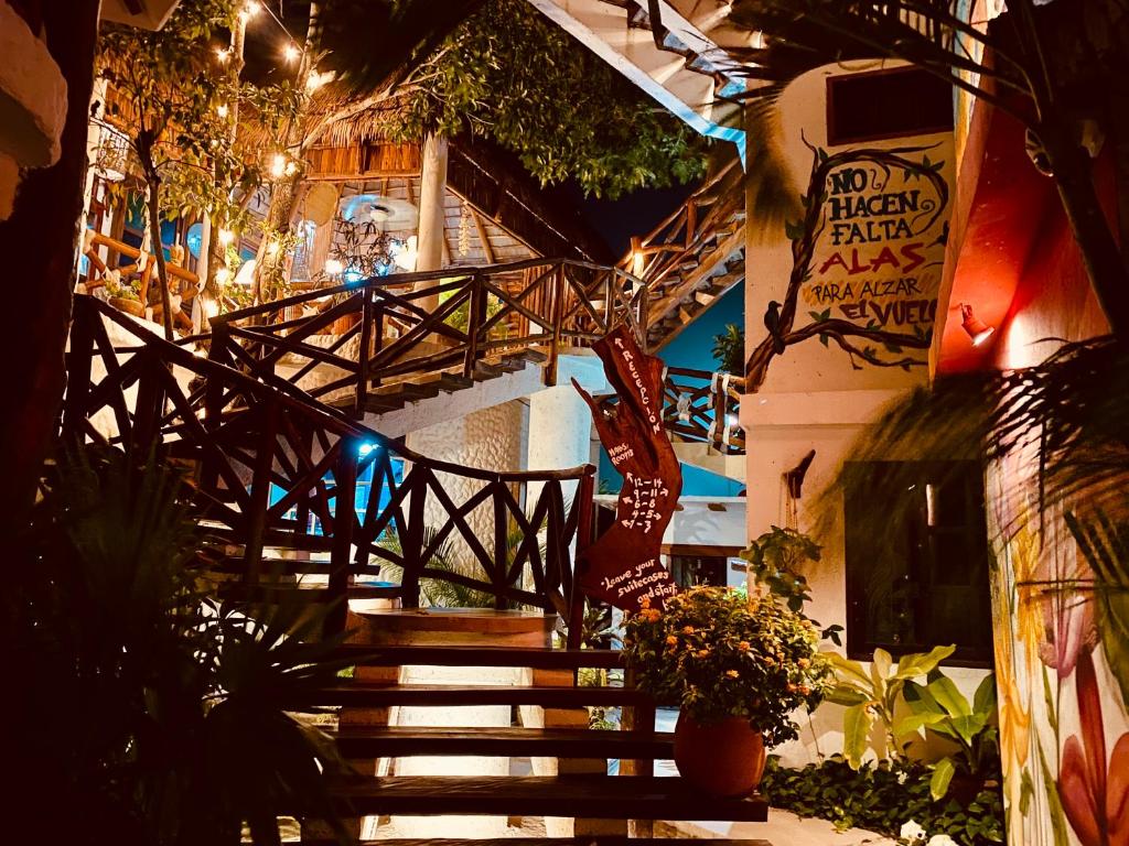a stairway leading to a building with a wooden staircase at Hotel Para Ti - Adults Only in Holbox Island