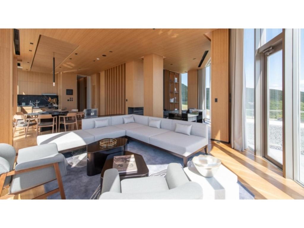 a living room with a couch and a table at Skye Niseko - Vacation STAY 41573v in Niseko