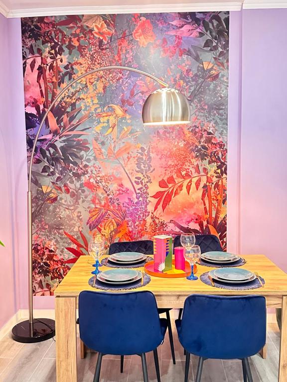 a dining room with a table with blue chairs at BOUTIQUE LUXURY City Center in Alicante