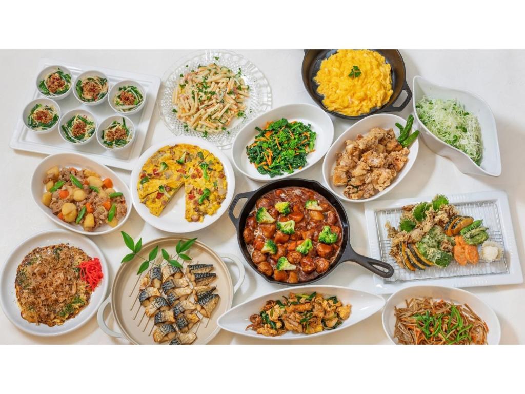a table with many different dishes of food on it at Sun Hotel Fukuyama - Vacation STAY 53469v in Fukuyama