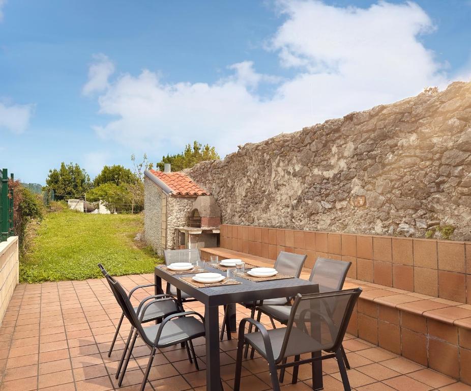 a table and chairs sitting on a patio at A Babor - 20805 in Argoños