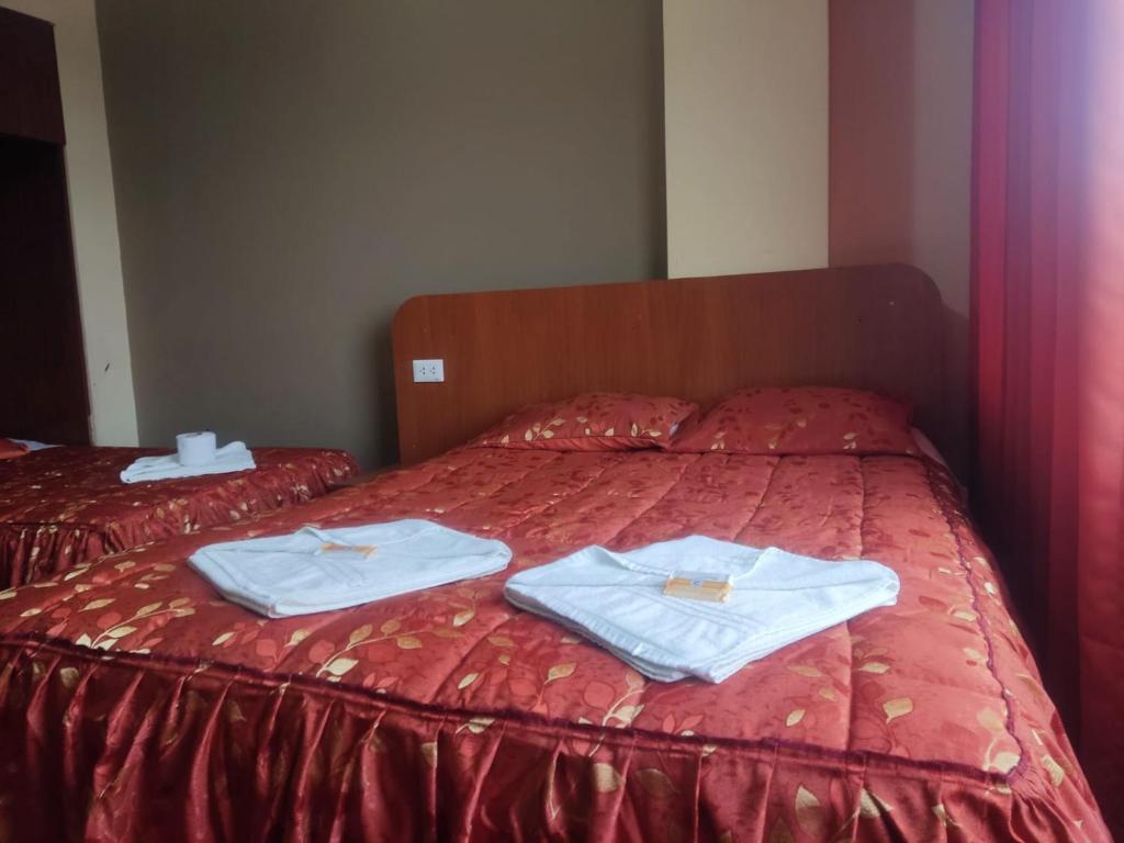 Postel nebo postele na pokoji v ubytování Hotel Arunta