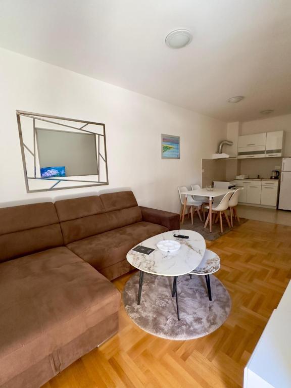a living room with a couch and a table at Matea in Budva