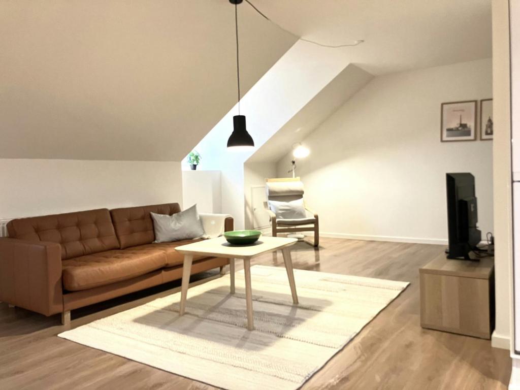 a living room with a couch and a table at Spacious Apartment for 4 in Esbjerg