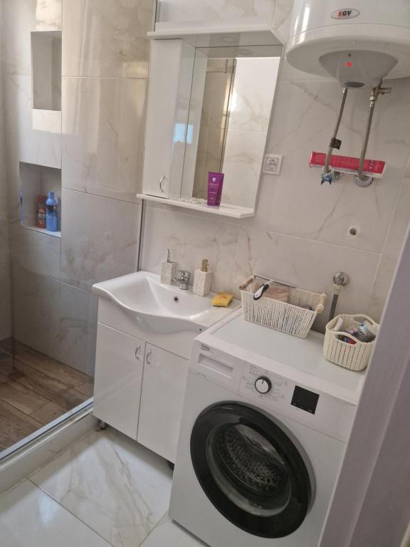 a white bathroom with a washing machine and a sink at Relax In in Belgrade