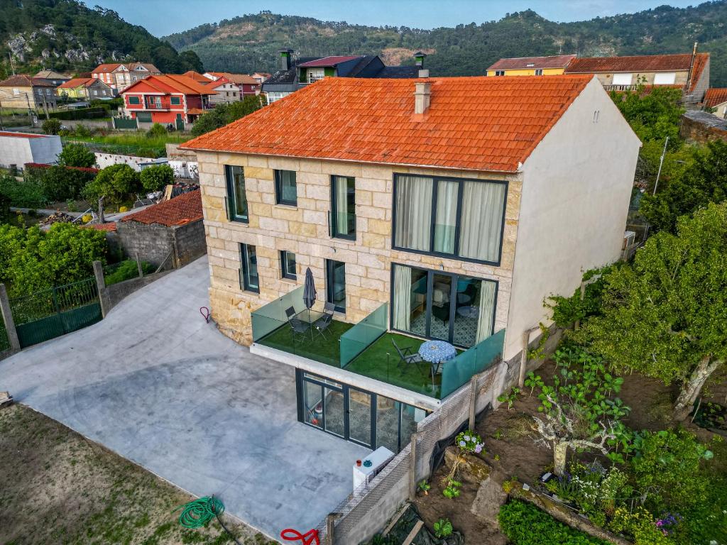 an aerial view of a house with an orange roof at O da Sina- Los refugios del capitán AS DE GUÍA in Aldán