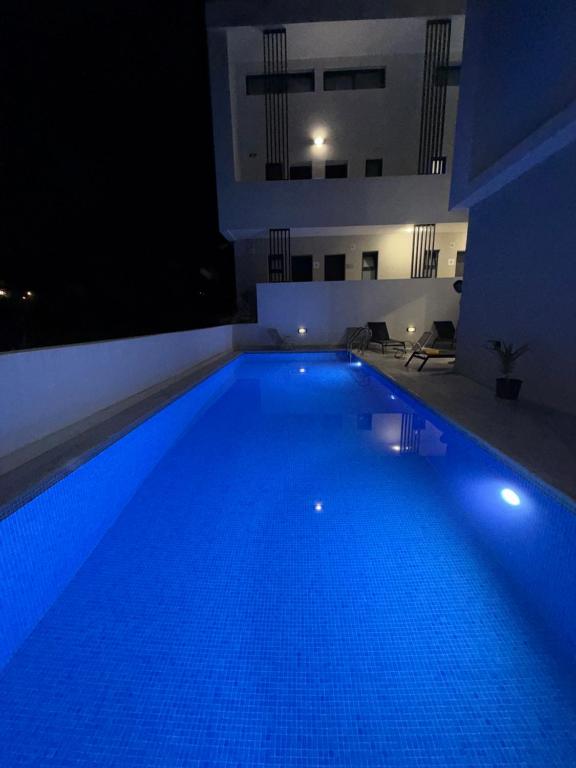 a large swimming pool at night in a building at kallithea maisonette in Kallithea Halkidikis