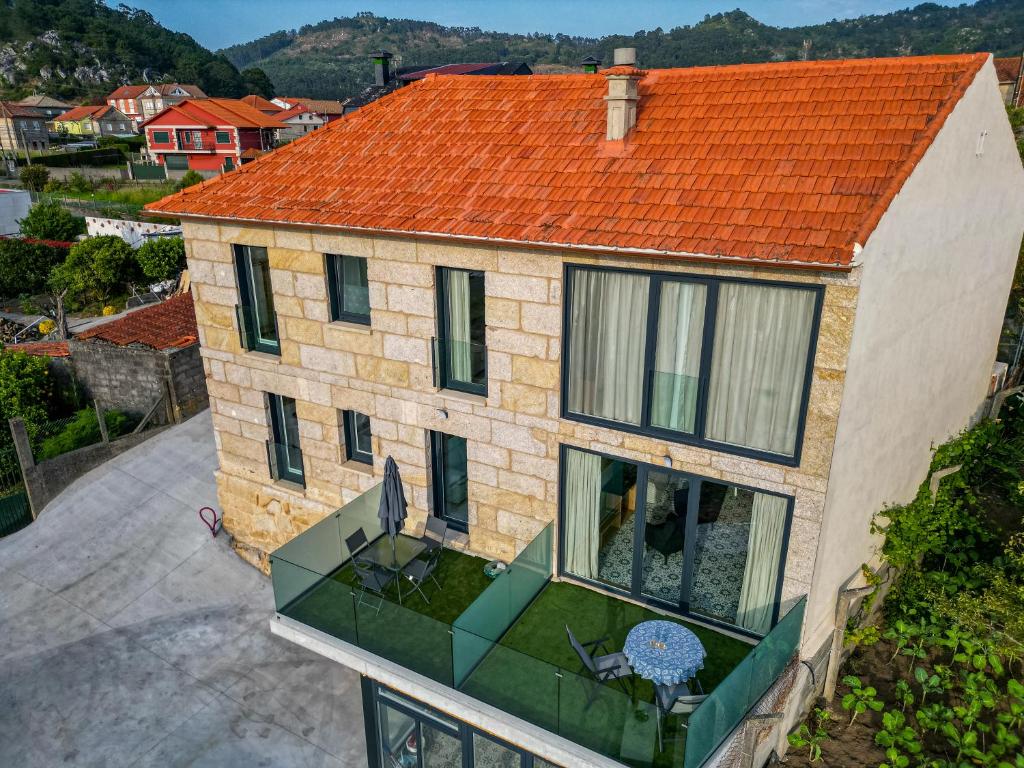 an aerial view of a house with an orange roof at O da Sina-Los refugios del capitán COTE in Aldán