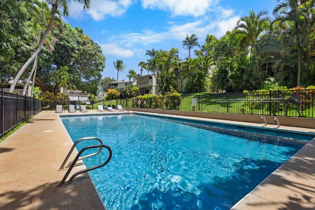 a swimming pool with a chair in a yard at Direct Oceanfront Beach Pohailani Studio - New in Kahana
