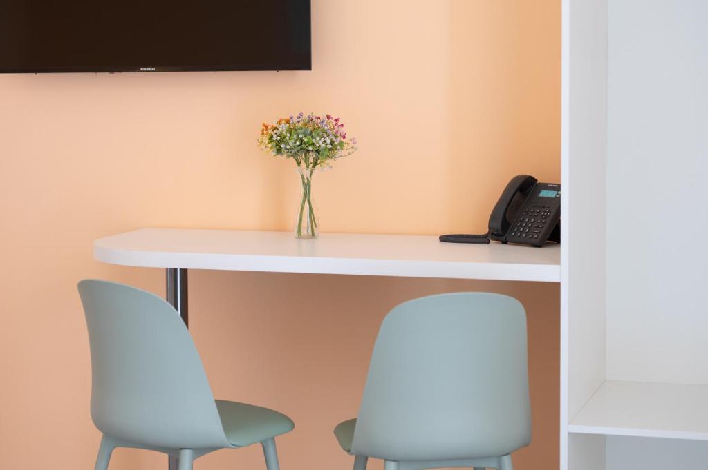 TV a/nebo společenská místnost v ubytování Aria Rooms