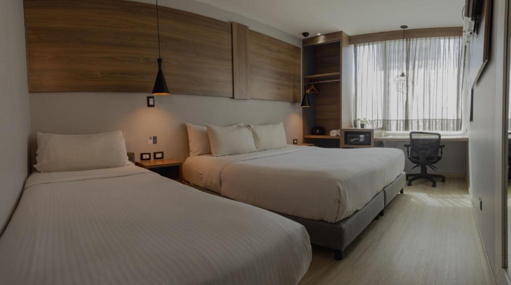 Postel nebo postele na pokoji v ubytování Hotel Blue Concept