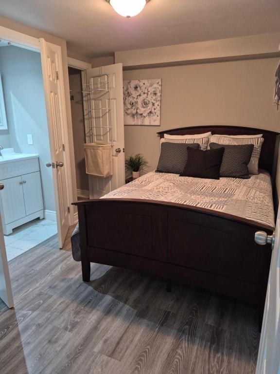 a bedroom with a large bed and a bathroom at Whitby one bedroom apartment in Whitby