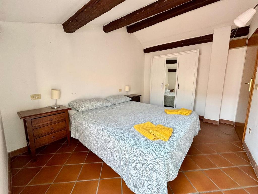 een slaapkamer met een bed met gele handdoeken erop bij Mansarda la Graziosa in Rimini