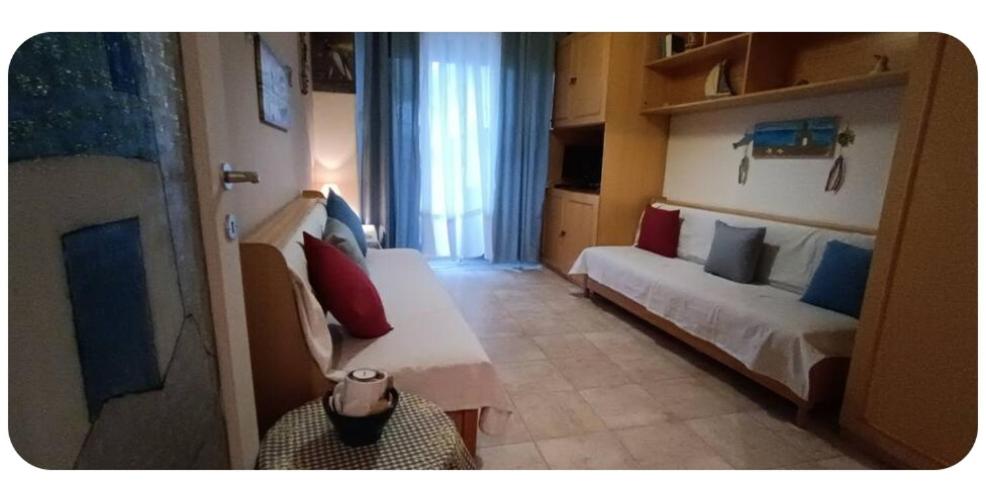 a small room with a bed and a couch at Sea view in Nea Peramos