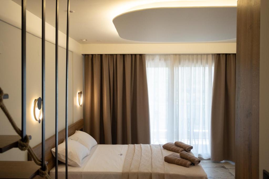 a bedroom with a bed and a large window at Minimalist suites in Potos