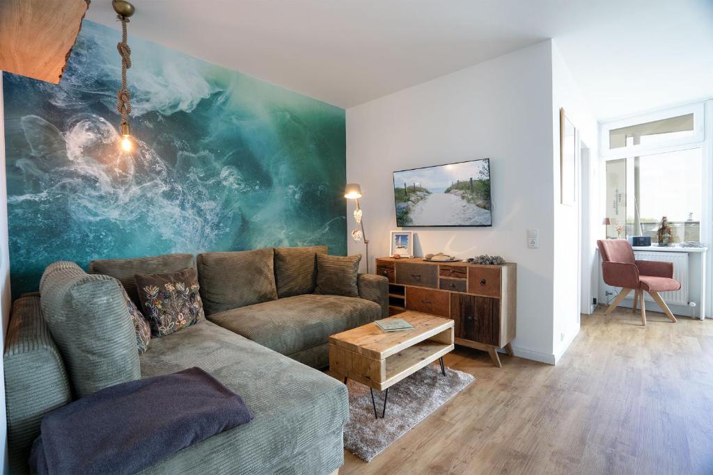 a living room with a couch and a table at Prinz Hamlet Wohnung Pelzi 51 in Pelzerhaken