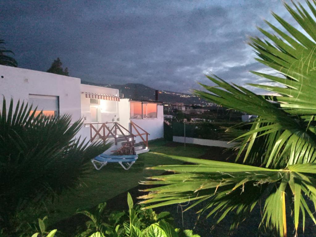 a backyard of a house with a blue bench at Vivaldi Summer in Icod de los Vinos