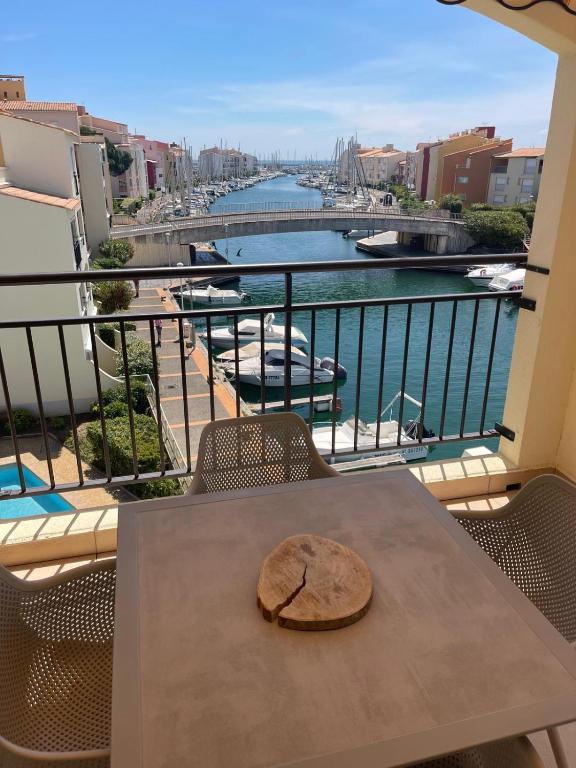 a plate on a table with a view of a river at loft appartement in Cap d'Agde