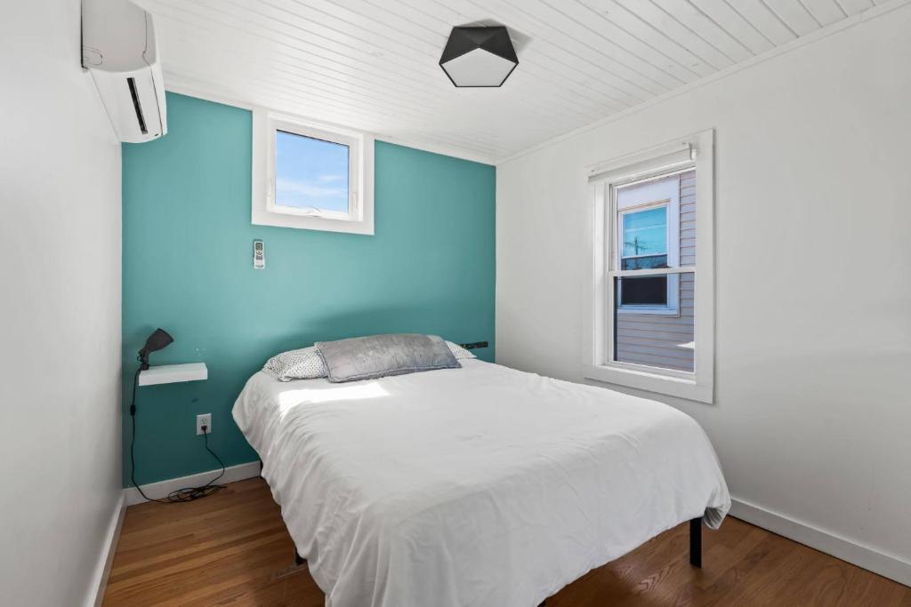 a bedroom with a bed with a blue wall at Whole House in Walker's Point in Milwaukee
