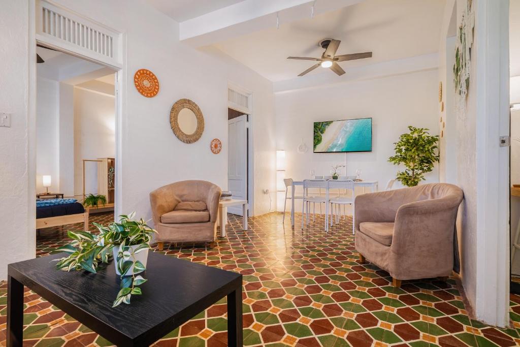a living room with two chairs and a table at Beachwalk San Juan by PH in San Juan