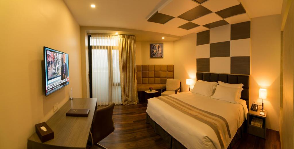 En eller flere senger på et rom på Hotel Parami