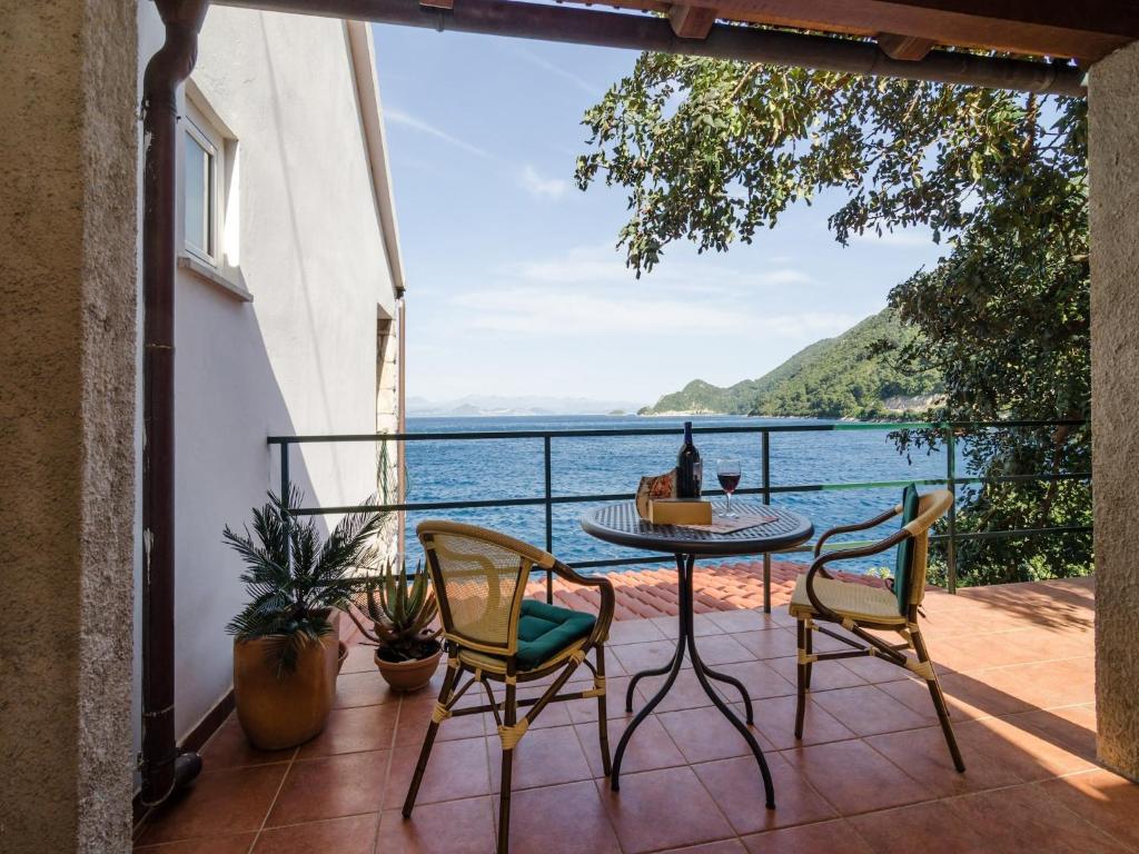 a balcony with a table and chairs and a view of the water at Apartments Aneli - Two Bedroom Apartment with Terrace and Sea View A2 in Sobra