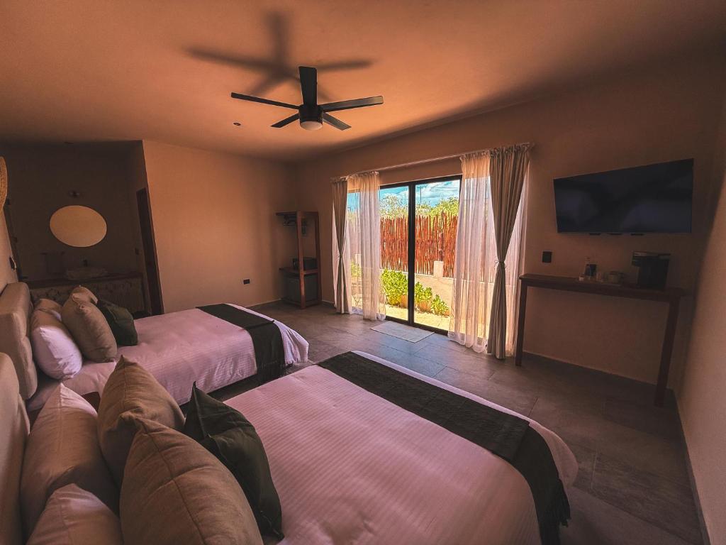 Ένα ή περισσότερα κρεβάτια σε δωμάτιο στο Casa Marassi Holbox