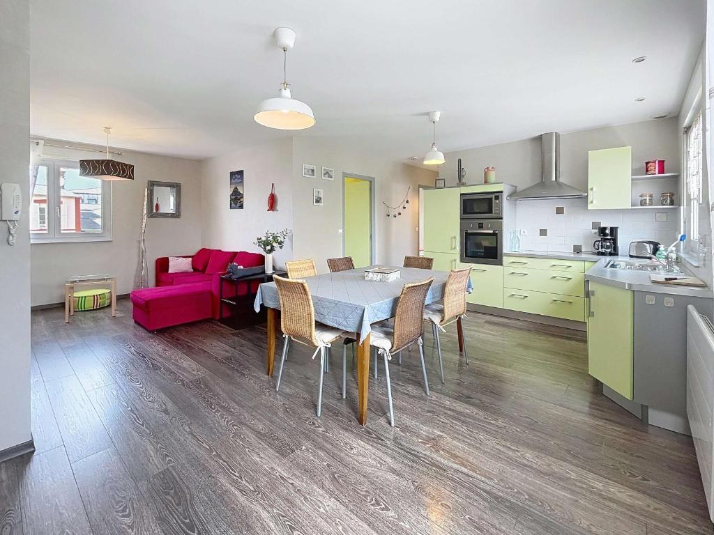 a kitchen and living room with a table and chairs at Appartement cosy à 200m de la mer, 2 chambres, centre-ville de St Pair-sur-Mer, parking inclus - FR-1-361-543 in Saint-Pair-sur-Mer
