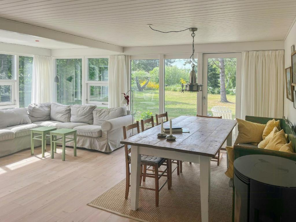 a living room with a couch and a table at Holiday Home At Fynshoved in Martofte