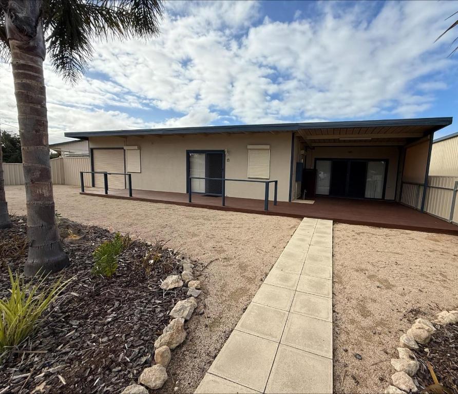 a building with a palm tree in front of it at Shore Beats Work in Stansbury