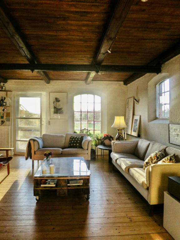 a living room with two couches and a coffee table at Experience The Sea And Starling Murmuration in Kolby Kås