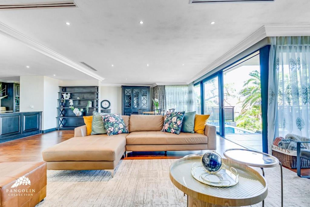 a living room with a couch and a table at Phezulu Villas 2, Zimbali Estate by Euphoric Leisure in Ballito