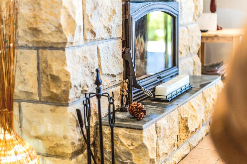 a stone wall with a mirror and a window at Aleah, Cathkin Estates by Euphoric Leisure in Champagne Valley