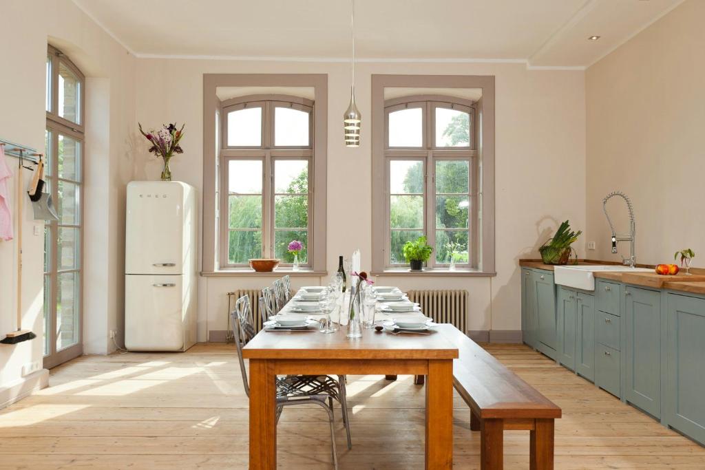 a kitchen with a table with chairs and a refrigerator at Spacious Apartment With Terrace And Garden View in Walow