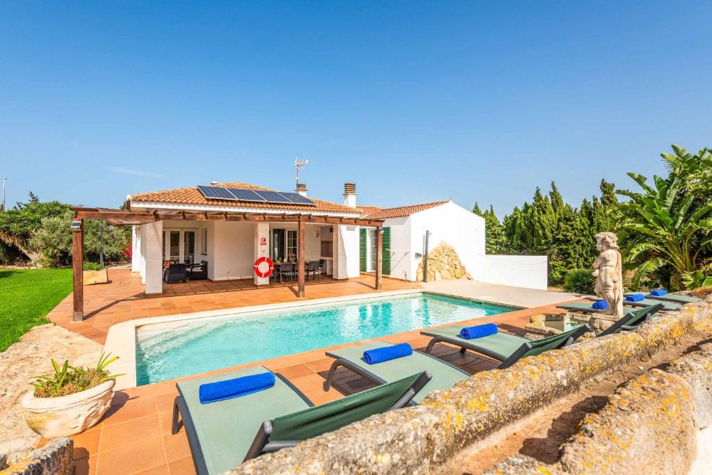 a villa with a swimming pool and a house at Bell Veure in Ciutadella
