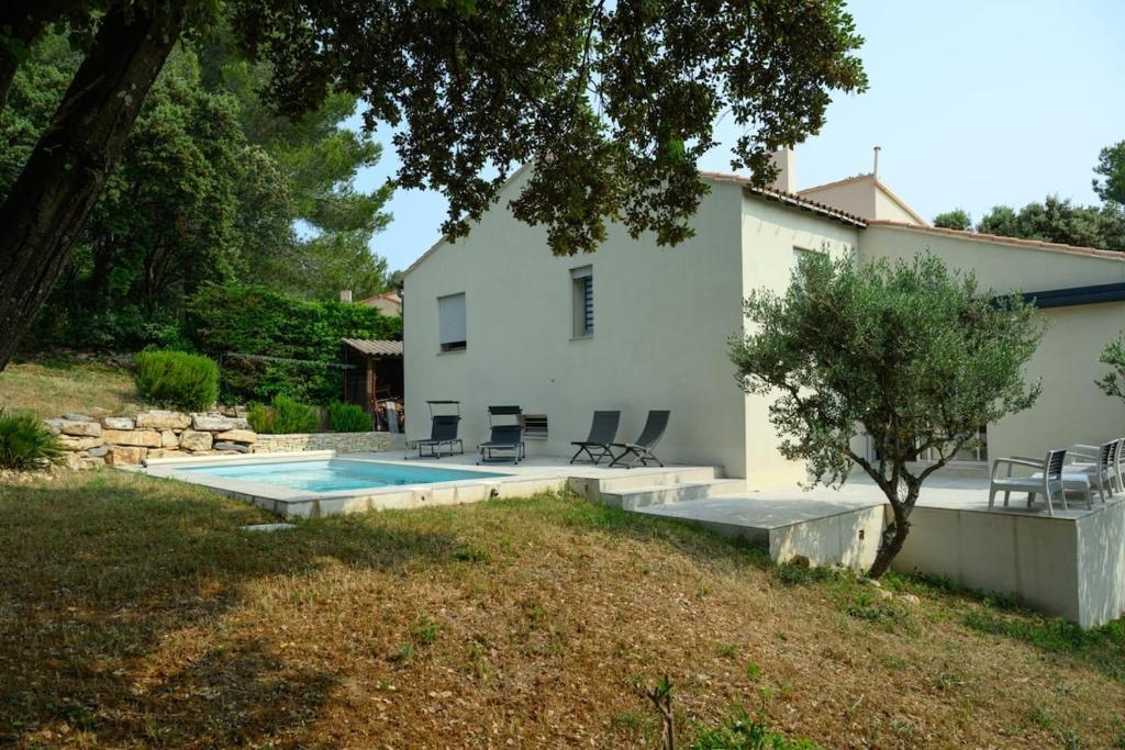 une maison avec une piscine dans la cour dans l'établissement La villa du Soleil, à Nîmes