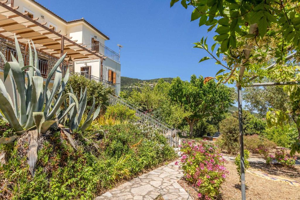 a house with a garden and a walkway at Odyssey's Palace - Escape in Mythical Ithaca in Platithriás