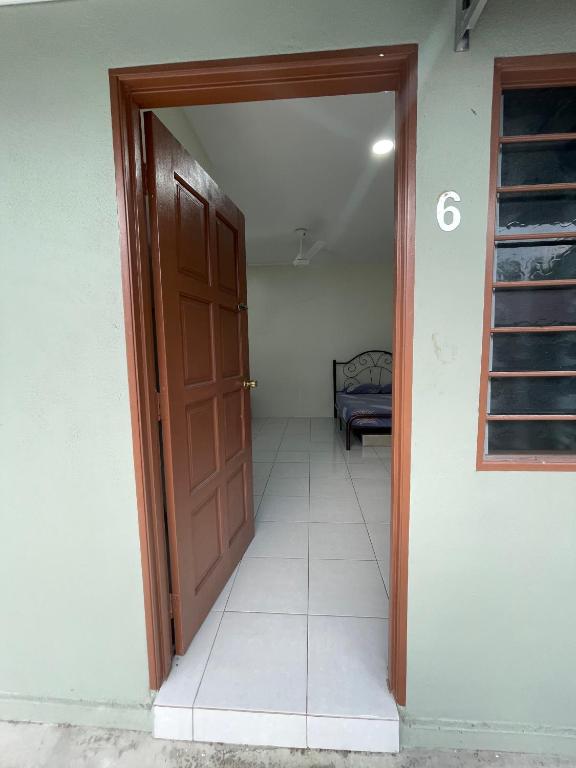 an open door to a room with a bedroom at Bilik Rehat Aircond Pekan in Pekan