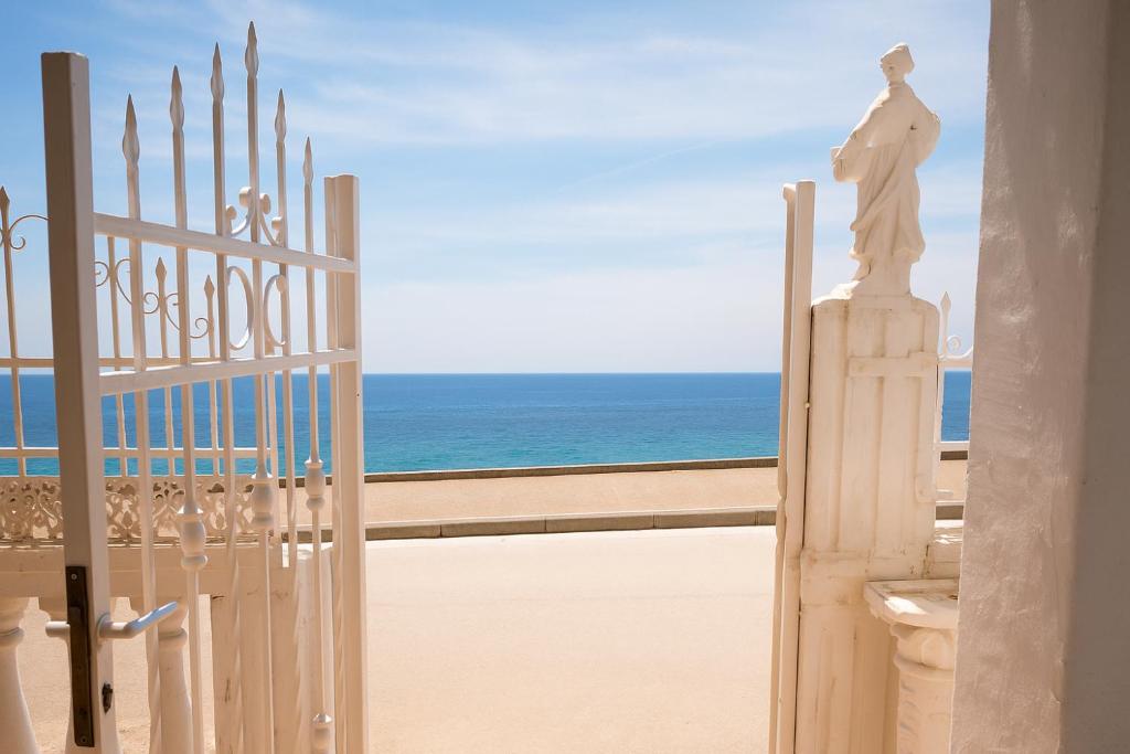 un cancello con una statua di fronte alla spiaggia di Beachfront Family Escape a Nea Kalikratia