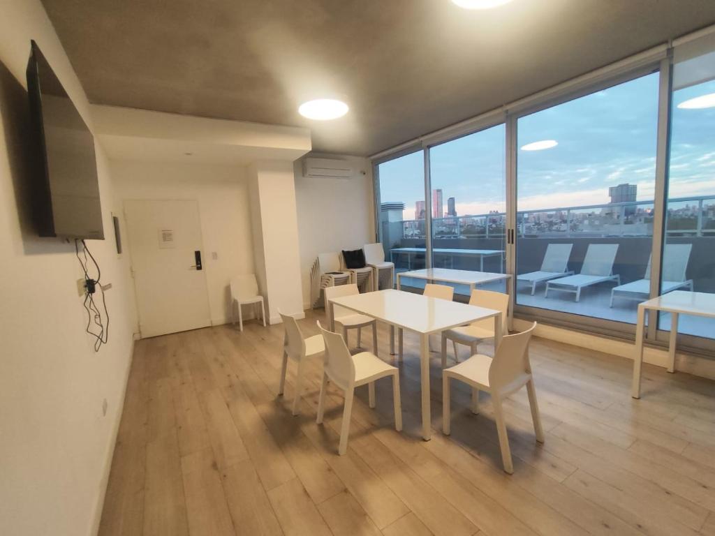 a room with a table and chairs and a large window at Lure Palermo Hollywood in Buenos Aires