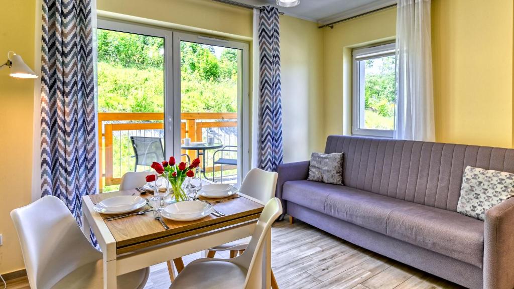 a living room with a couch and a table at Waryńskiego, Sun & Snow in Szklarska Poręba