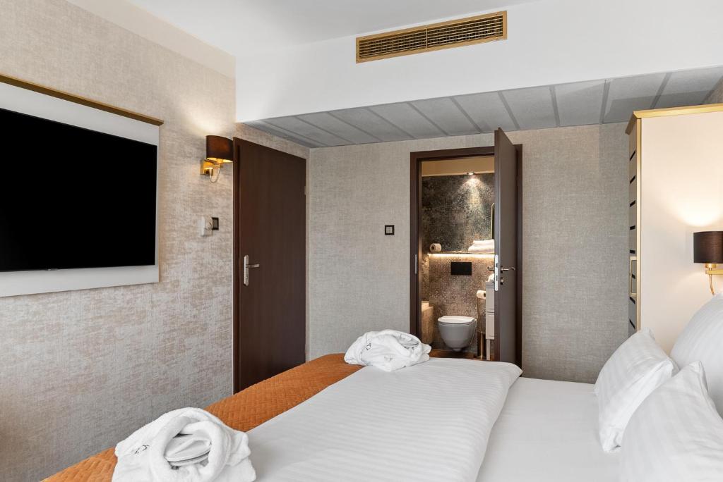 Ein Bett oder Betten in einem Zimmer der Unterkunft Park Hotel Diament Katowice