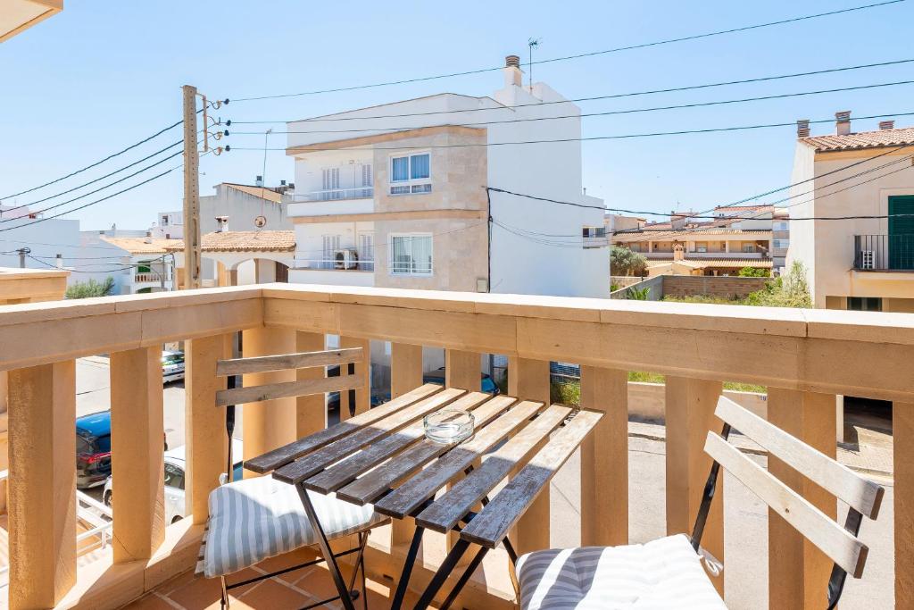 a wooden balcony with a wooden table and chairs at Can Vidal Ibiza in Ses Salines