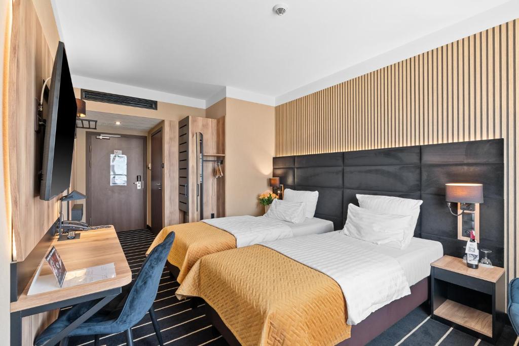 Ein Bett oder Betten in einem Zimmer der Unterkunft Park Hotel Diament Katowice