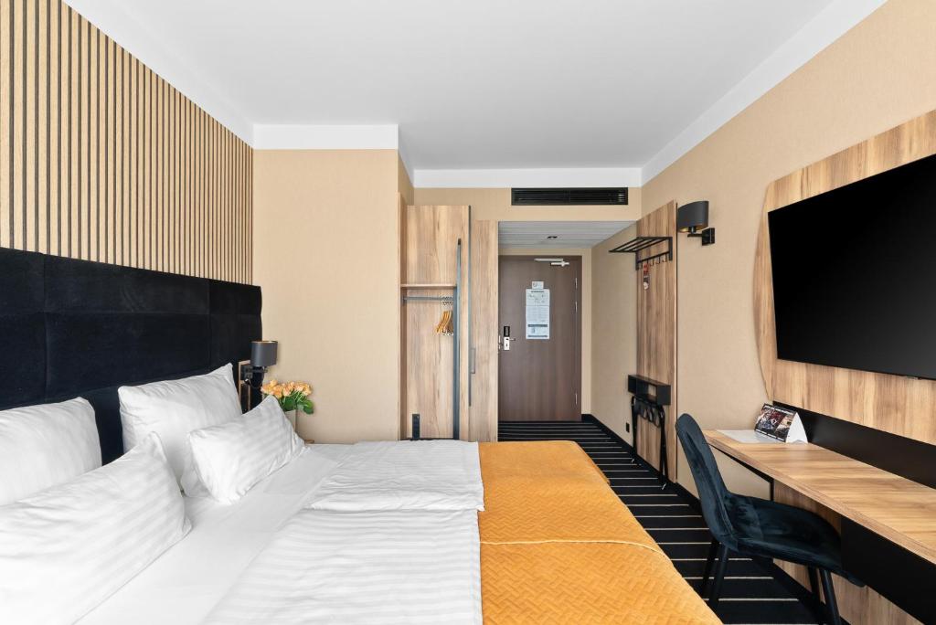 Ein Bett oder Betten in einem Zimmer der Unterkunft Park Hotel Diament Katowice