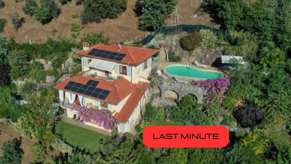 a house with solar panels on top of it at Villa Romantica Sea View in Camaiore