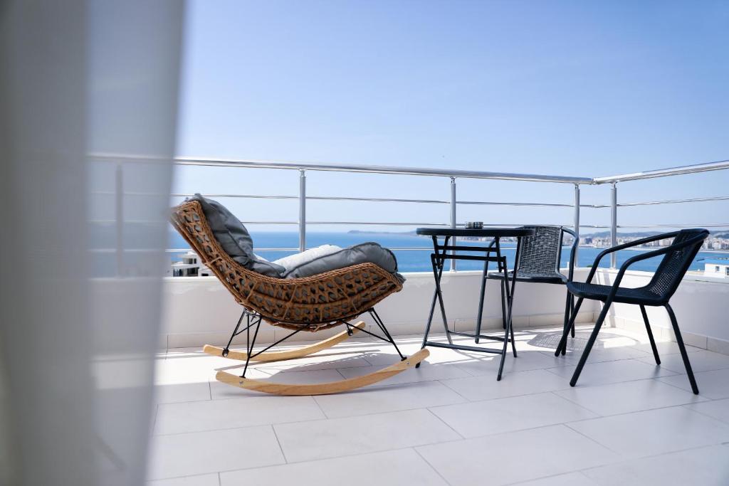 a balcony with a chair and a table on a balcony at Villa Christianna Free Parking in Vlorë