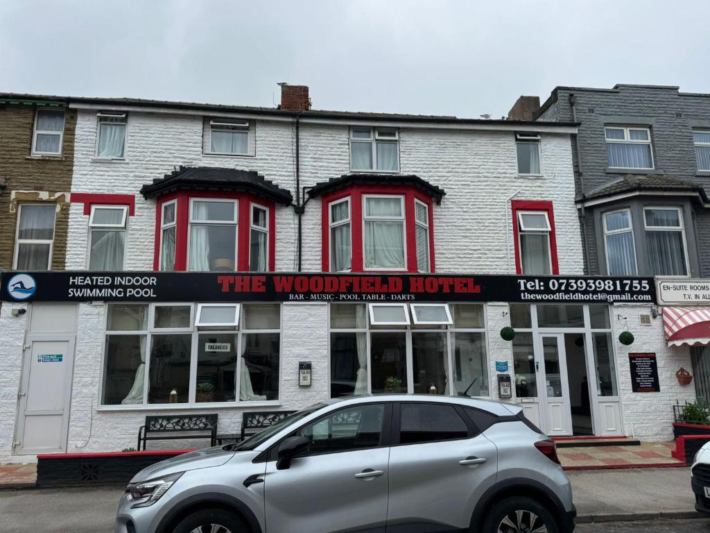 a silver car parked in front of a building at The Woodfield Hotel , Indoor Heated swimming pool, Spacious lounge and Bar in Blackpool