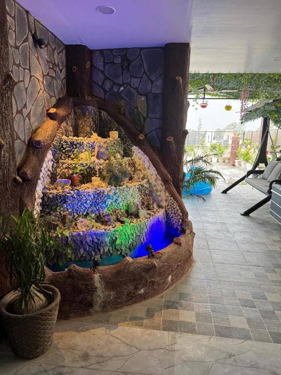 a garden made out of a log in a room at Urban Nest in Dehradun