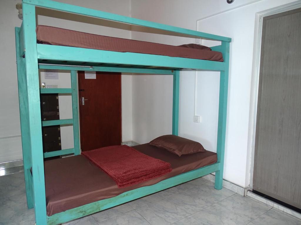 Postel nebo postele na pokoji v ubytování Ceylon Glory Hostel